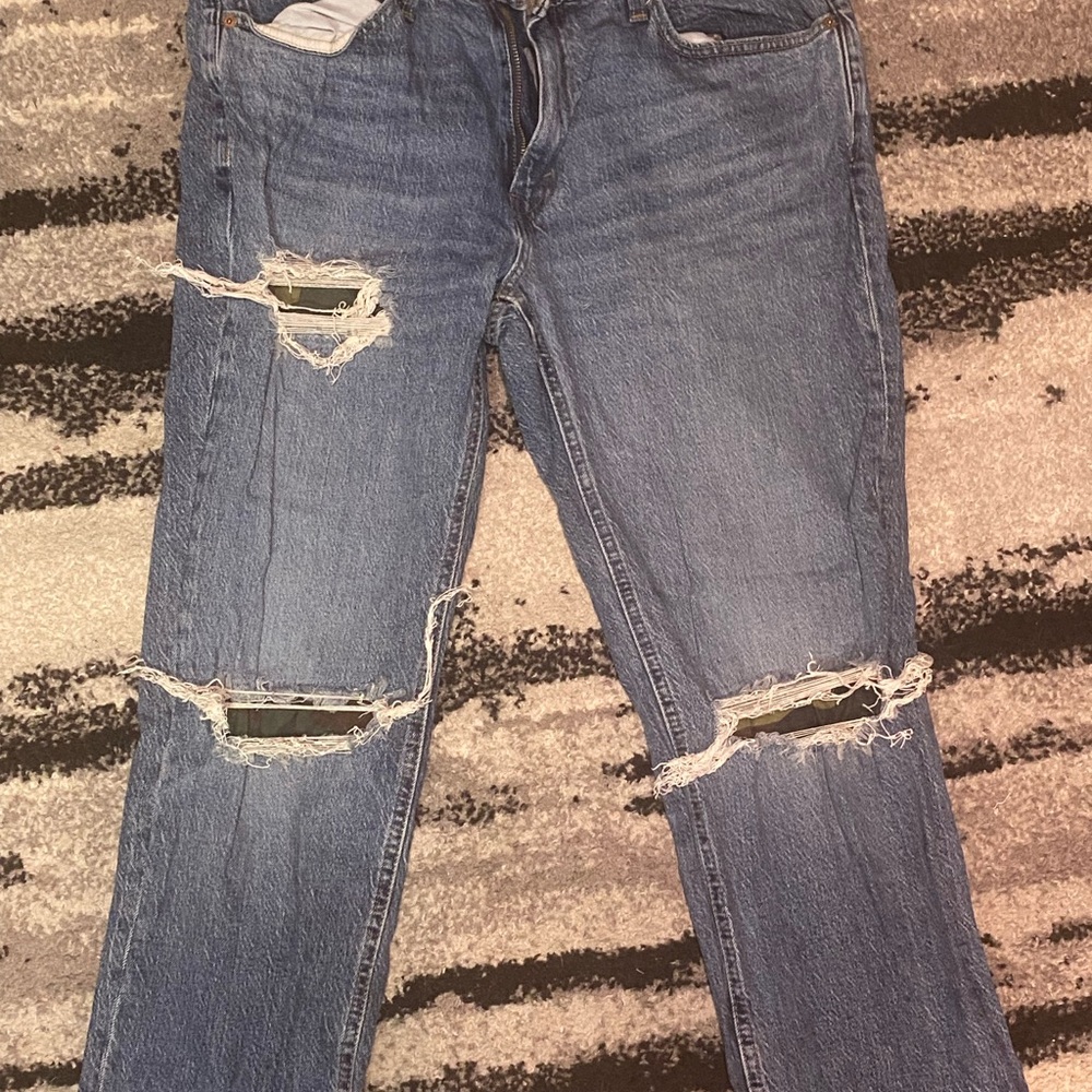 Levi’s Distressed Blue Jeans with camouflage in rips